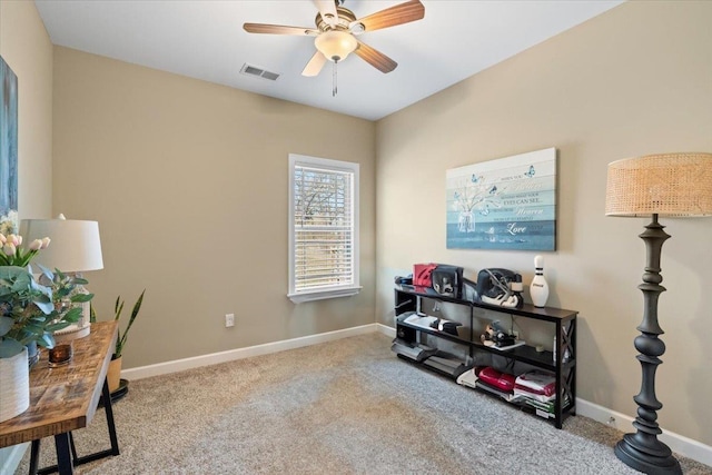 carpeted home office featuring visible vents, ceiling fan, and baseboards