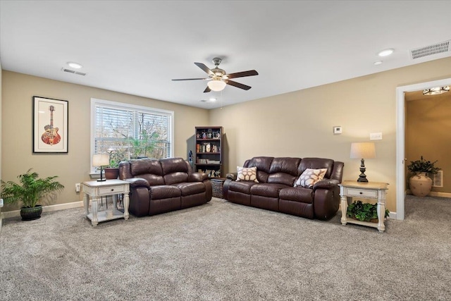 living area featuring baseboards, visible vents, and carpet flooring