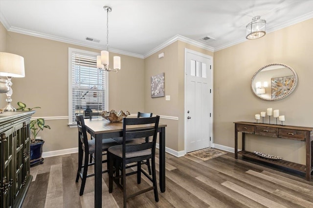 dining area featuring crown molding, visible vents, and dark wood-type flooring