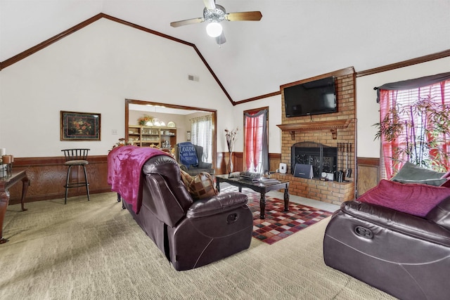 carpeted living room featuring a brick fireplace, visible vents, ornamental molding, and wainscoting