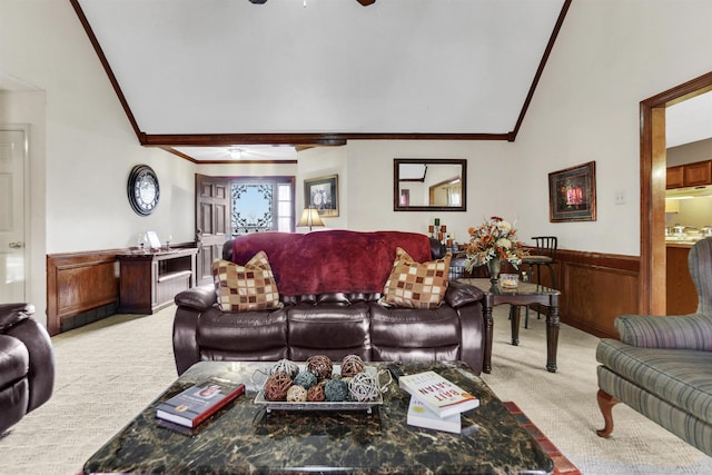 living room featuring crown molding, wainscoting, a ceiling fan, and light colored carpet