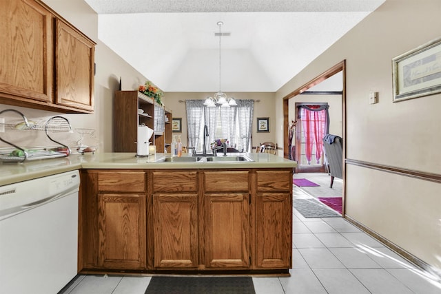 kitchen with a peninsula, a sink, vaulted ceiling, dishwasher, and brown cabinetry