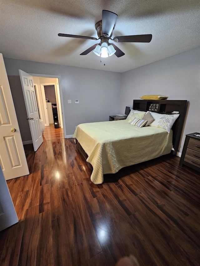 bedroom featuring a textured ceiling, wood finished floors, a ceiling fan, and baseboards