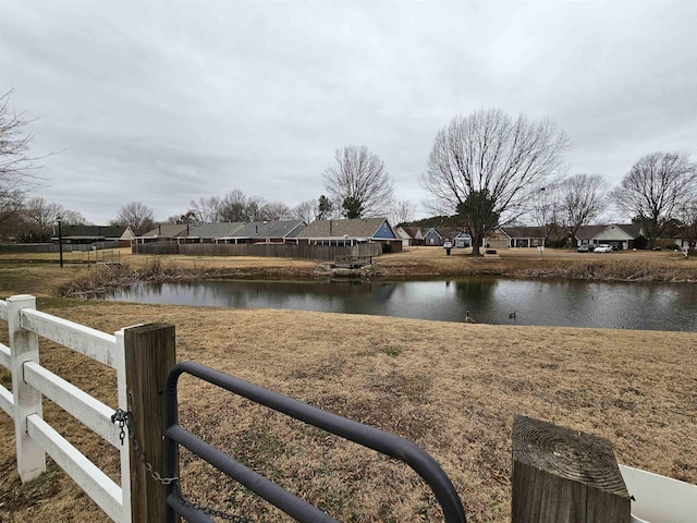 water view featuring a residential view and fence