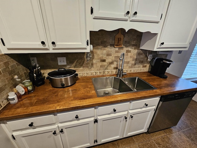 kitchen with a sink, butcher block countertops, white cabinets, and dishwasher