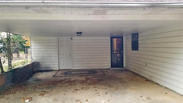 property entrance featuring a carport and fence