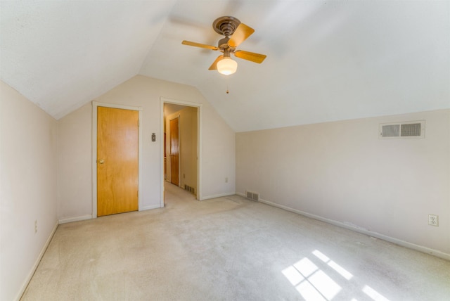 additional living space featuring lofted ceiling, carpet, visible vents, and baseboards