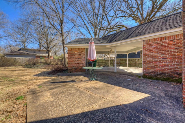 view of yard featuring driveway, fence, and a patio