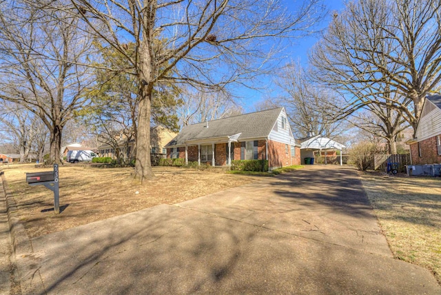 view of front facade with driveway and brick siding