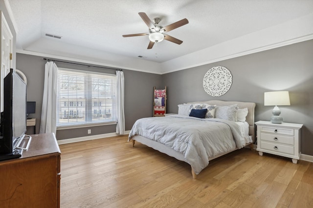 bedroom featuring light wood-style flooring, visible vents, and baseboards