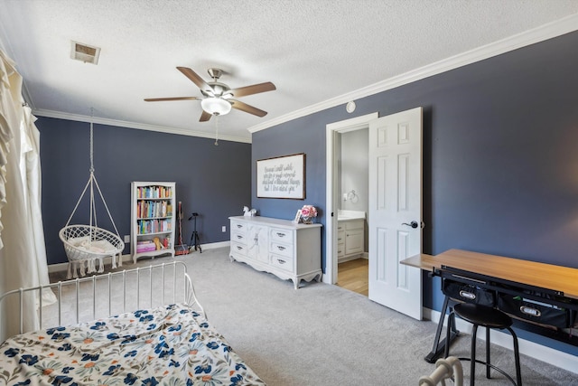 bedroom with a textured ceiling, connected bathroom, carpet flooring, visible vents, and ornamental molding