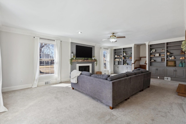 living room with light carpet, a fireplace, a ceiling fan, visible vents, and baseboards