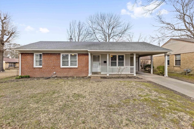 single story home featuring a porch, an attached carport, brick siding, driveway, and roof with shingles