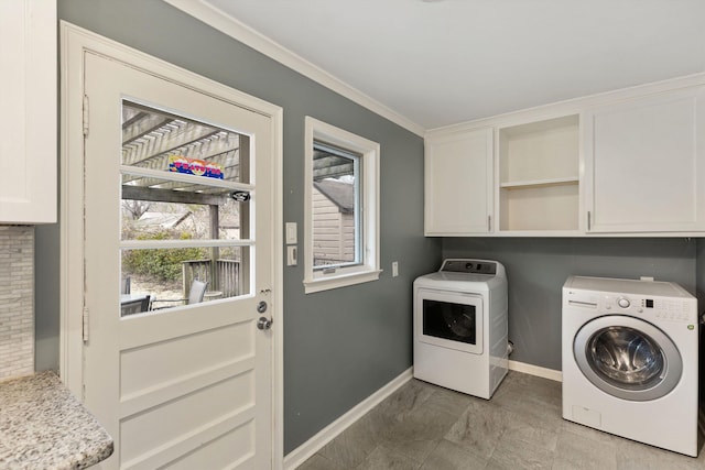 washroom with separate washer and dryer, cabinet space, and baseboards