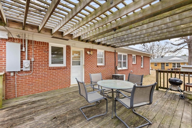 deck featuring a pergola and outdoor dining space