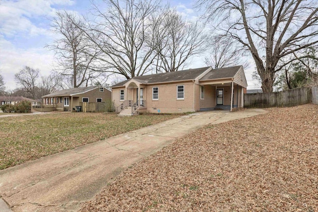 ranch-style home featuring a front lawn, crawl space, fence, and brick siding