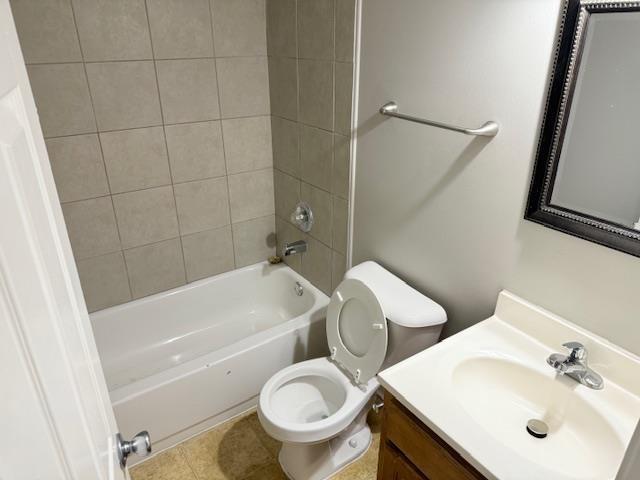 full bath featuring washtub / shower combination, vanity, toilet, and tile patterned floors