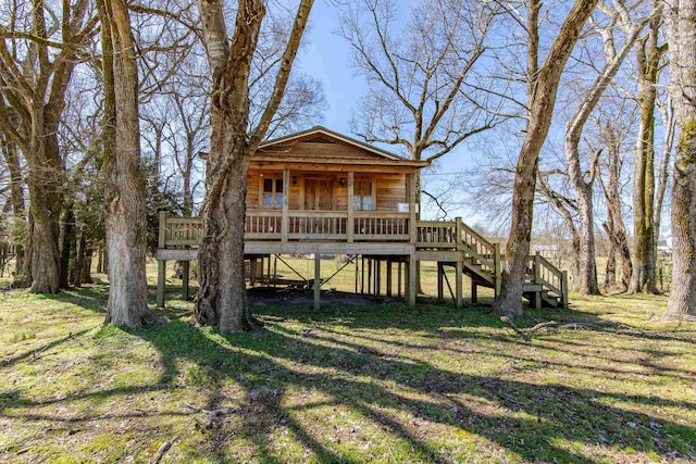 view of front of house with a front lawn and stairway