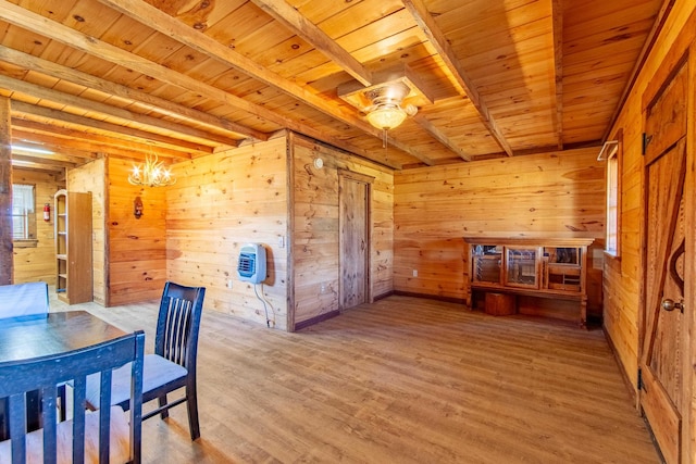 dining space with ceiling fan with notable chandelier, wood walls, wood finished floors, wood ceiling, and beam ceiling