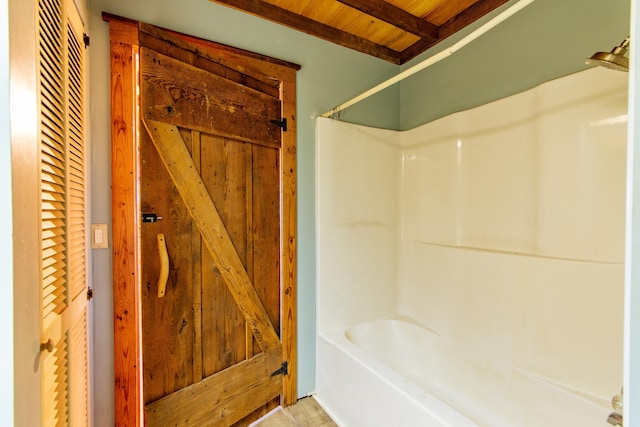 full bathroom featuring  shower combination, wood ceiling, and beam ceiling