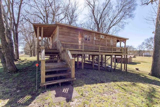 exterior space featuring a wooden deck, stairway, and a front lawn