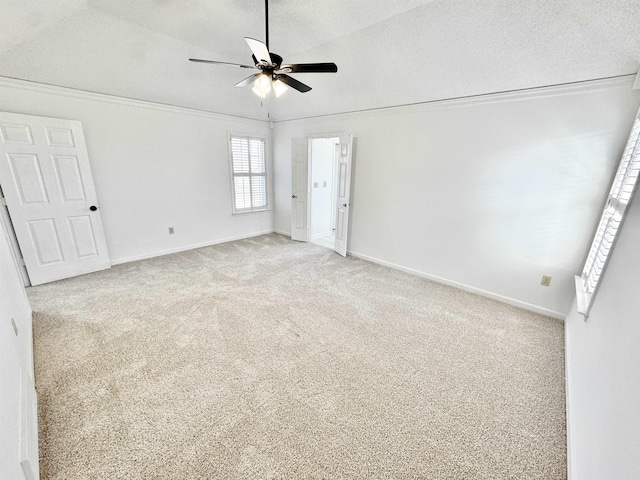 unfurnished bedroom with a textured ceiling, ceiling fan, baseboards, and light colored carpet