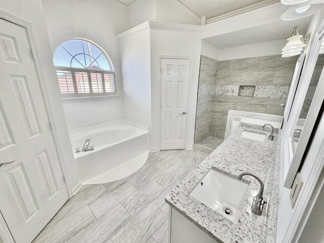 full bathroom with double vanity, a garden tub, walk in shower, and a sink