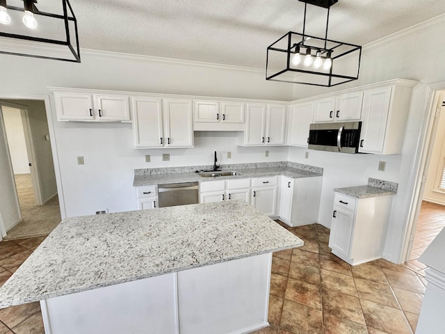 kitchen featuring stainless steel appliances, a sink, white cabinetry, and light stone countertops