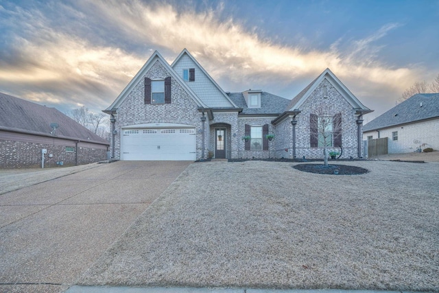 view of front of house with an attached garage, concrete driveway, and brick siding