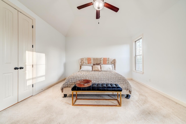 carpeted bedroom with lofted ceiling, ceiling fan, and baseboards