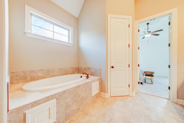 full bathroom featuring vaulted ceiling, ceiling fan, tile patterned flooring, and a garden tub