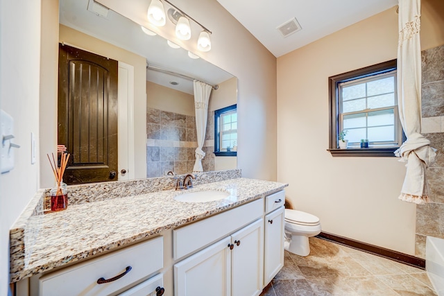 bathroom featuring baseboards, visible vents, vanity, and toilet