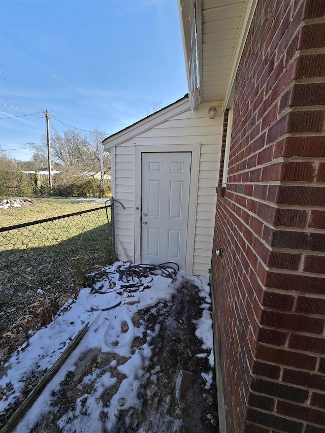 exterior space featuring brick siding and fence