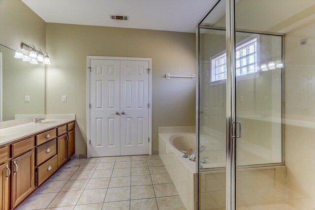 full bathroom featuring a garden tub, tile patterned flooring, vanity, visible vents, and a stall shower