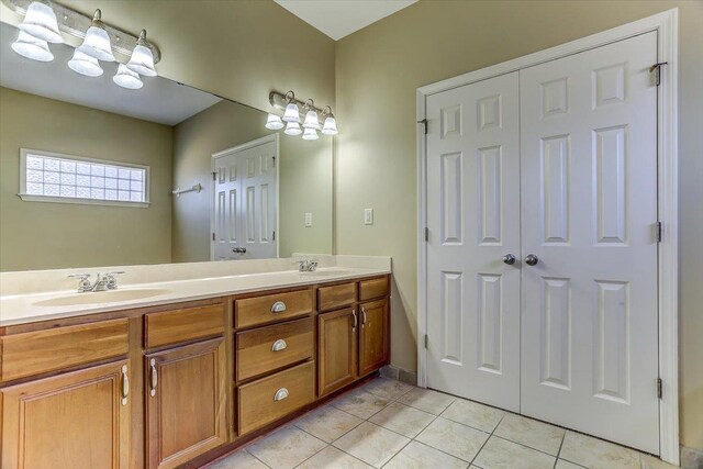 bathroom featuring double vanity, a sink, and tile patterned floors