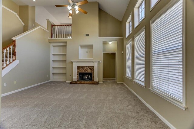 unfurnished living room featuring built in features, baseboards, carpet, a fireplace, and high vaulted ceiling