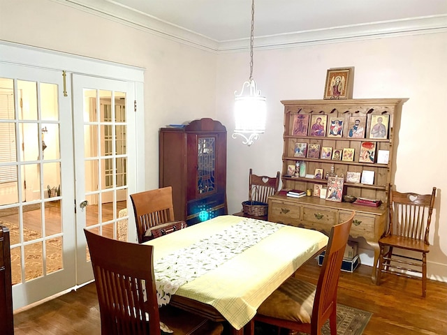 dining area with french doors, crown molding, baseboards, and wood finished floors