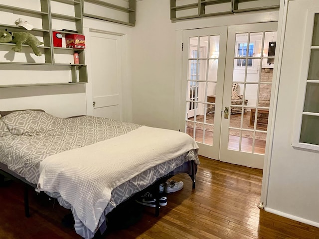 bedroom with hardwood / wood-style flooring, baseboards, and french doors