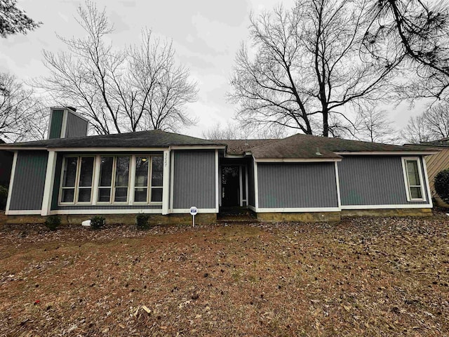 back of property with a chimney