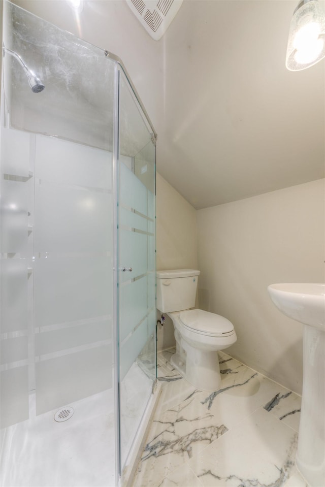 bathroom featuring marble finish floor, visible vents, toilet, vaulted ceiling, and a shower stall