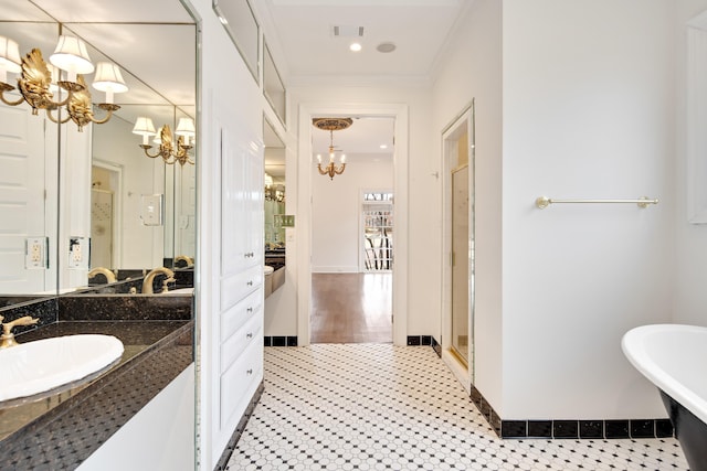 full bathroom featuring crown molding, visible vents, vanity, a shower stall, and a chandelier