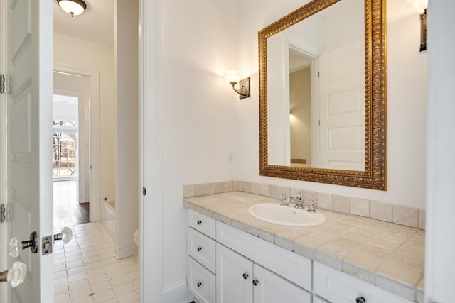 full bath with a bathtub, vanity, and toilet