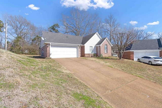 single story home featuring a garage, concrete driveway, brick siding, and a front lawn