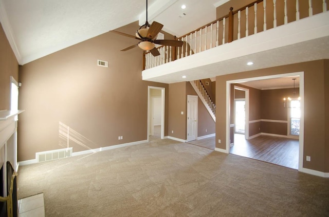 unfurnished living room with ornamental molding, carpet, visible vents, and baseboards