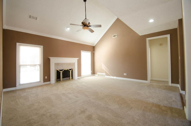 unfurnished living room with a tile fireplace, visible vents, crown molding, and baseboards