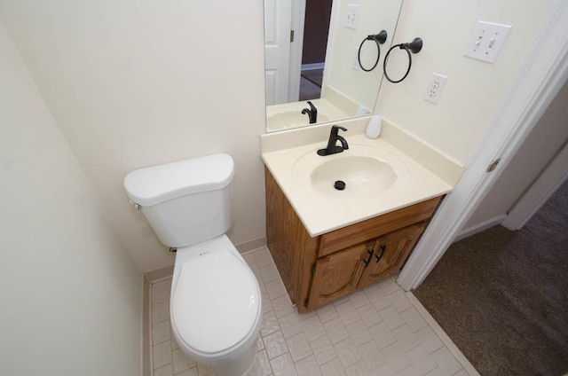 half bathroom featuring vanity and toilet