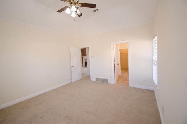 unfurnished bedroom featuring light carpet, ornamental molding, visible vents, and baseboards