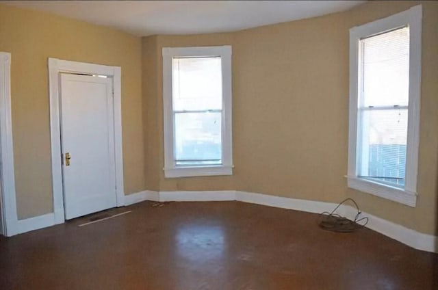 unfurnished bedroom with multiple windows and baseboards