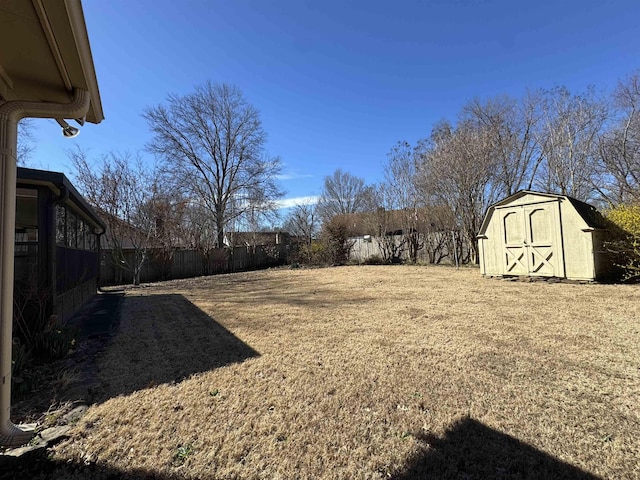 view of yard with an outdoor structure, fence, and a shed