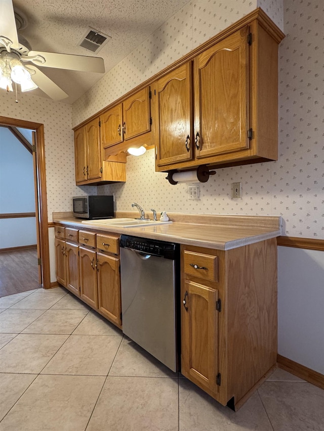 kitchen featuring wallpapered walls, visible vents, appliances with stainless steel finishes, a sink, and light tile patterned flooring